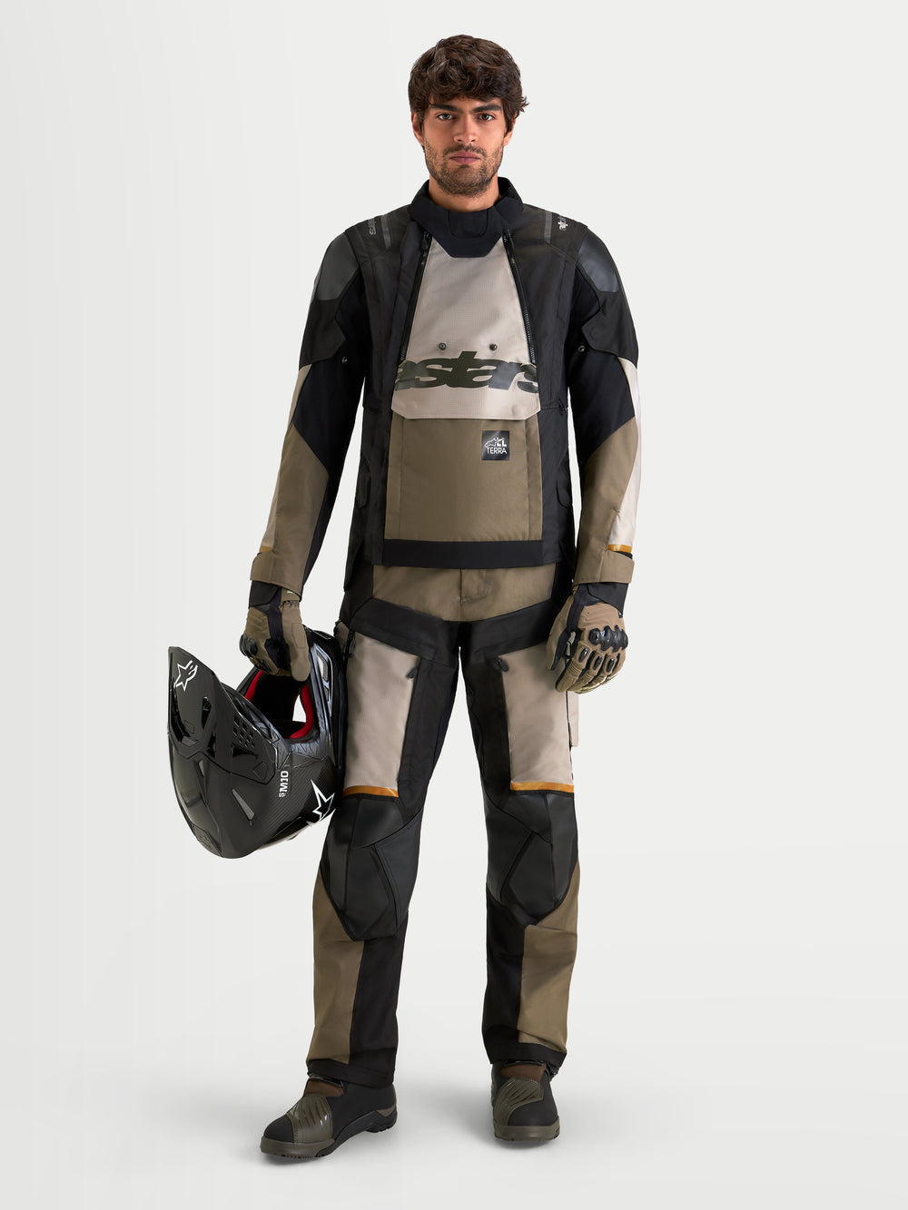 Alpinestars Harok V2 Drystar Pants, Men's All-Terra Adventure Motorcycle Pants, Aluminum, Walnut, and Black, CE Level 2 knee armor, worn by a male rider holding a helmet