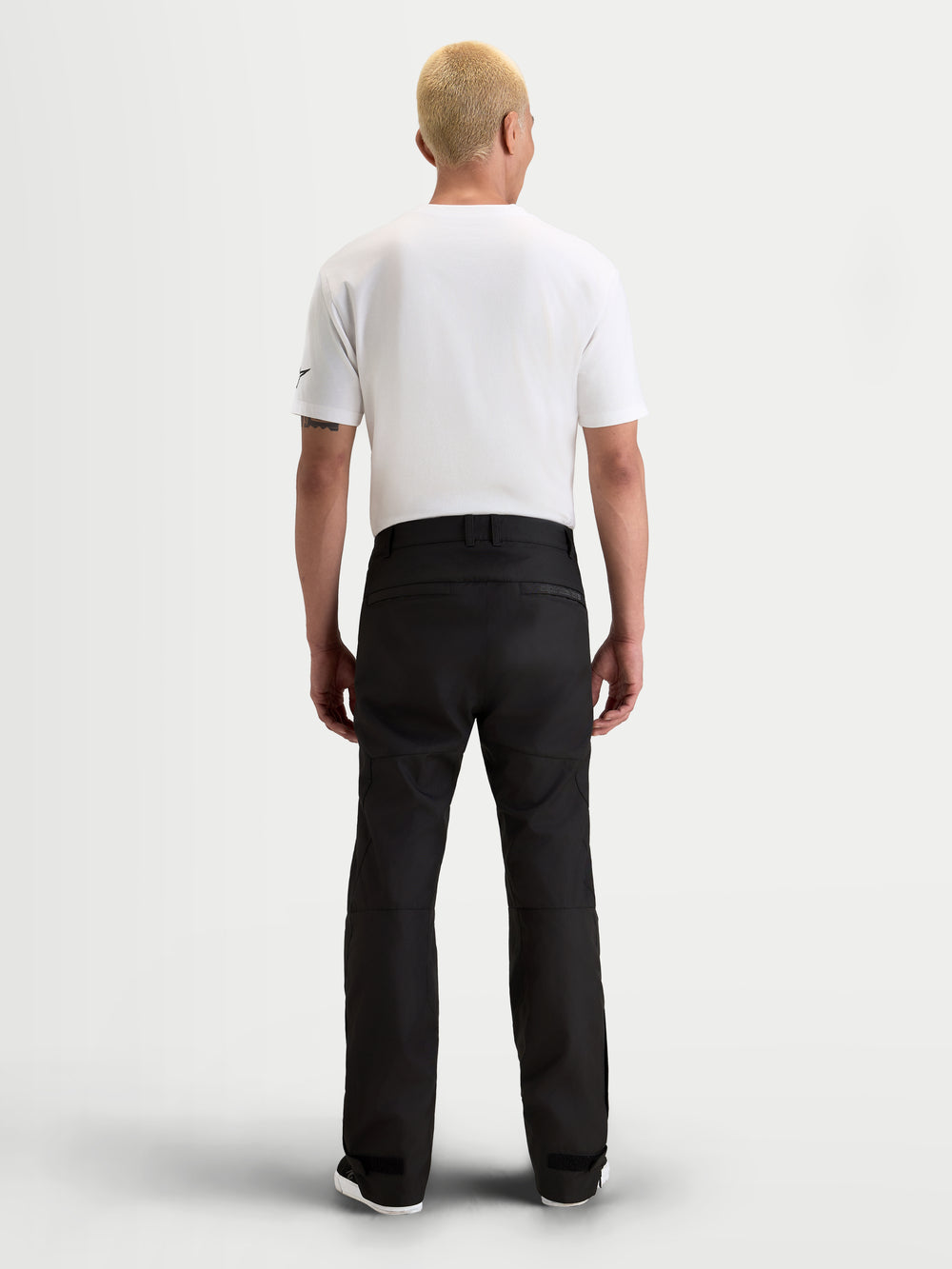 Alpinestars C-1 Waterproof Pants, men's urban contemporary motorcycle riding pants in black, rear view on a model wearing a white t-shirt and waterproof textile gear