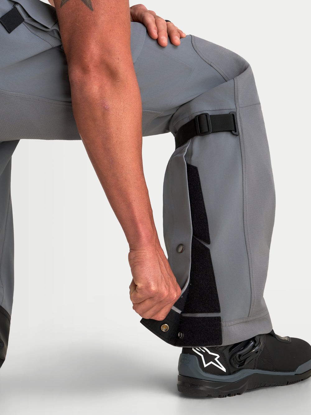 Alpinestars Maxdura Drystar XF Laminated Pants, Men's Adventure Motorcycle Pants in Dark Gray Black, featuring adjustable lower leg construction and over-the-boot fit with black riding boots