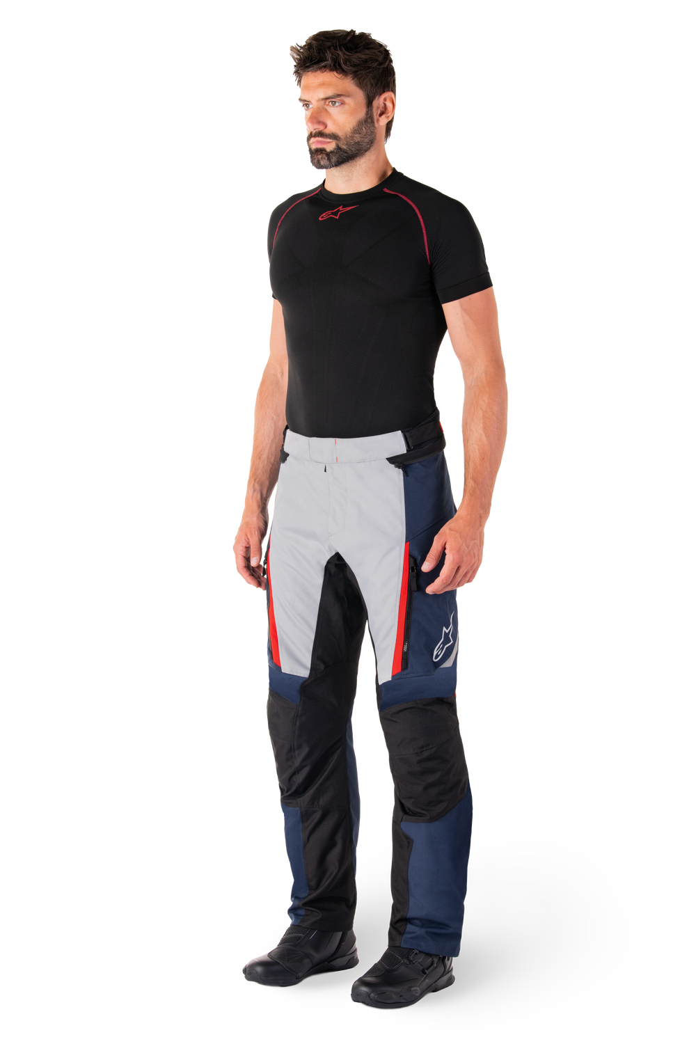 Alpinestars St-1 Waterproof Pants, Motorcycle Touring Pants, Dark Blue Black and Bright Red, worn by model with black base layer and black boots, features zippered pockets and Alpinestars logo on the leg