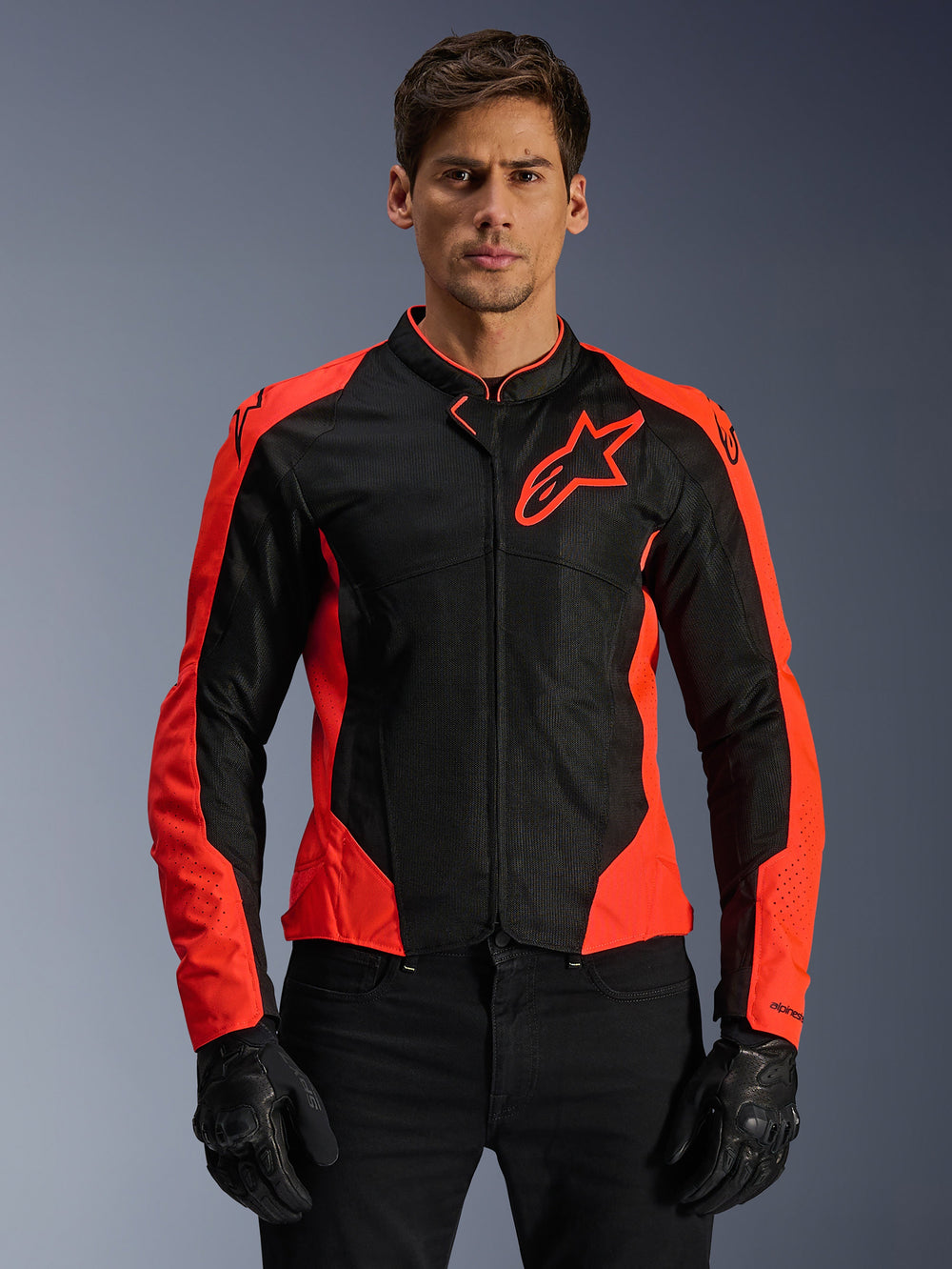 Alpinestars Viper Air V4 Jacket, Motorcycle Racing Jacket, Red Fluo and Black, worn by model with black gloves, tech mesh panels for ventilation, sporty design with Alpinestars star logo on the chest