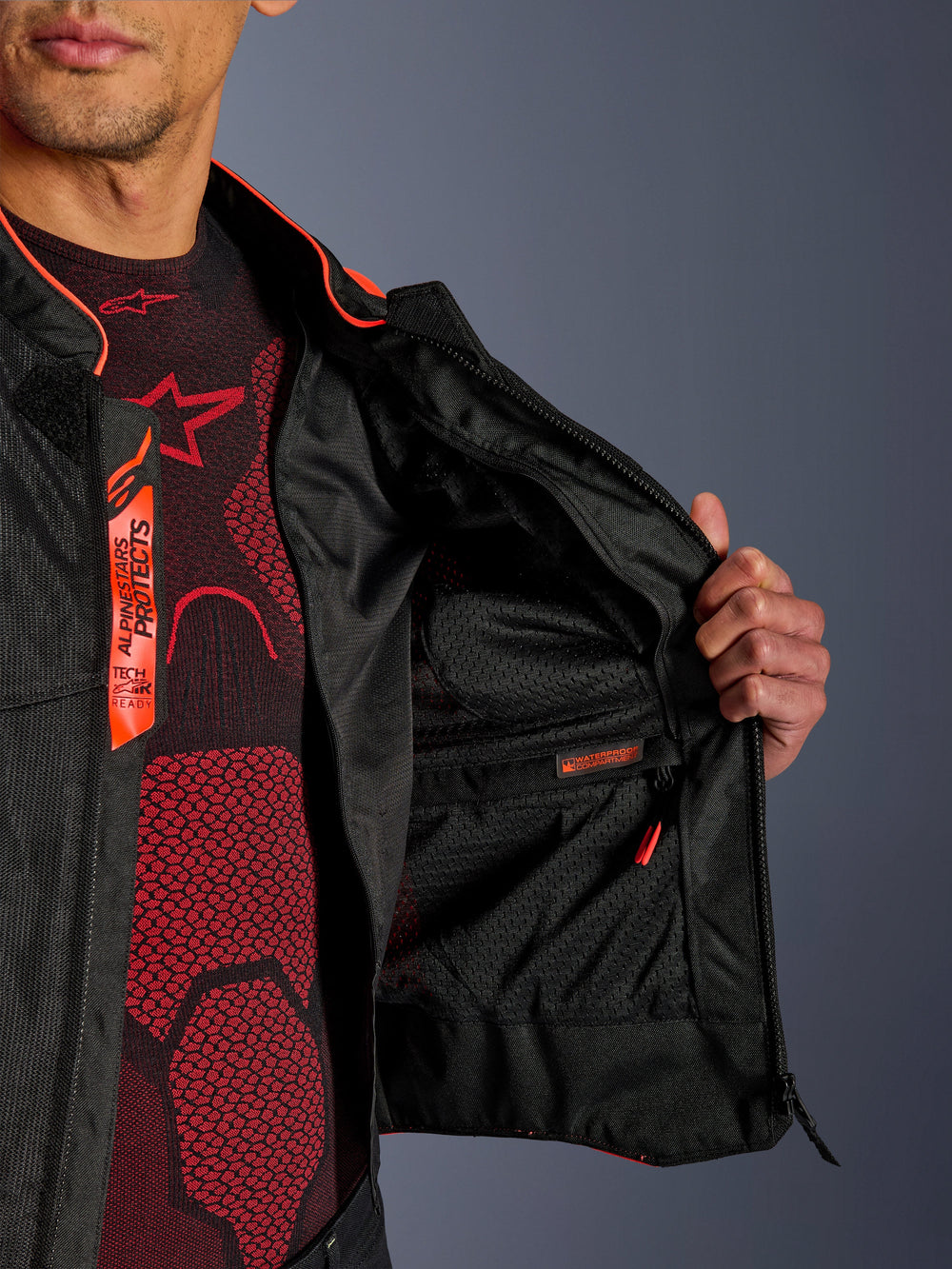 Alpinestars Viper Air V4 Jacket interior detail, showing the waterproof inner compartment and breathable tech mesh lining, Red Fluo and Black accents with Tech-Air Ready branding