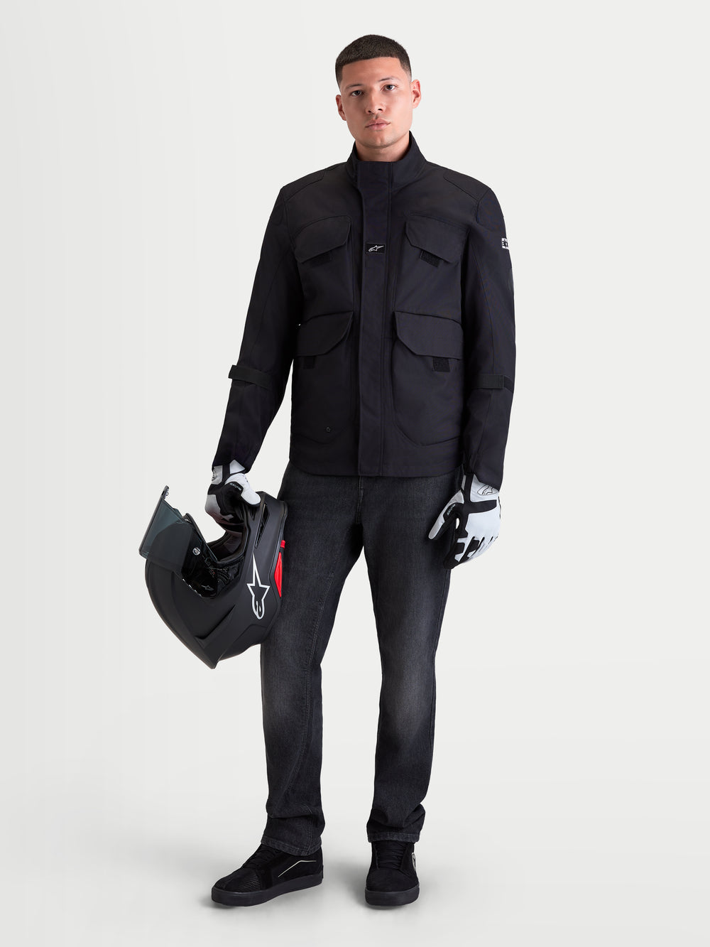 Alpinestars Flex-AST 8 Denim Pants Short, men's urban motorcycle riding jeans in Used Black, worn by a model holding a helmet and matching gear, AA-certified protective textile apparel