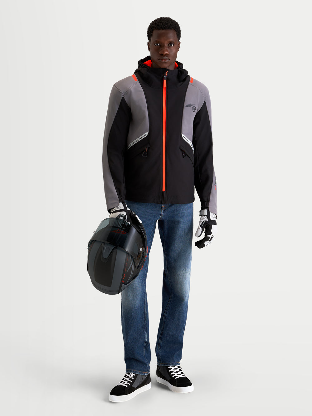 Alpinestars Flex-AST 8 Denim Pants Short, men's urban motorcycle riding jeans in medium blue, worn by a model standing with jacket, helmet, and riding gear, AA certified single-layer technical denim with COOLMAX comfort