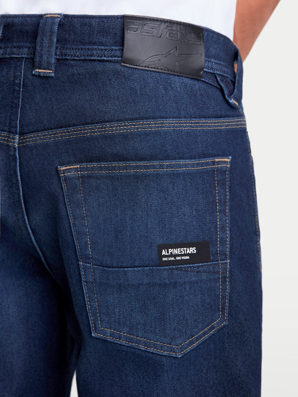 Alpinestars Flex-AST 7 Denim Pants Short, men's urban motorcycle riding jeans, dark blue, rear close-up view showing leather back patch, back pocket with Alpinestars label, and contrast stitching, AA certified technical denim