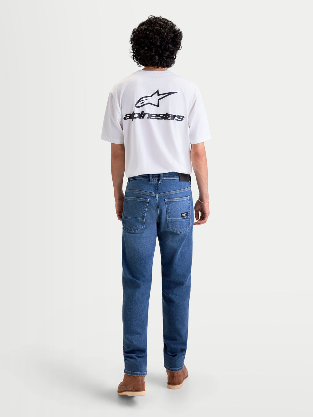 Alpinestars Flex-AST 7 Denim Pants Short, men's urban motorcycle riding jeans in light blue, rear view on a model wearing a white t-shirt, featuring a five-pocket layout and AA-rated technical denim construction