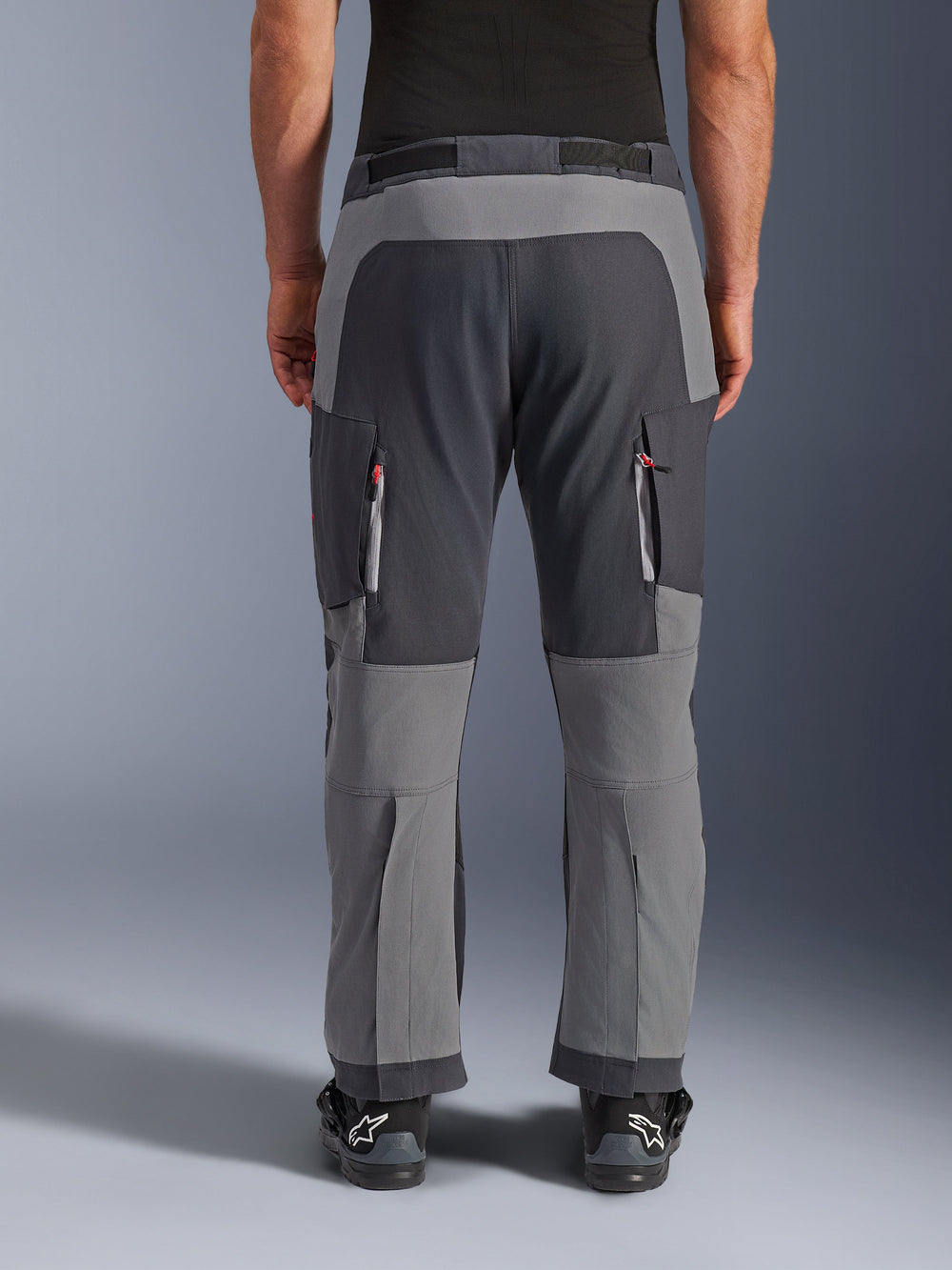 Alpinestars Maxdura Dual Pants, Adventure Motorcycle Pants, Dark Gray and Deep Gray, back view highlighting reinforced seat and knee panels, zippered thigh vents, worn with black Alpinestars boots, rugged stretch polyamide construction for dual-sport riding.