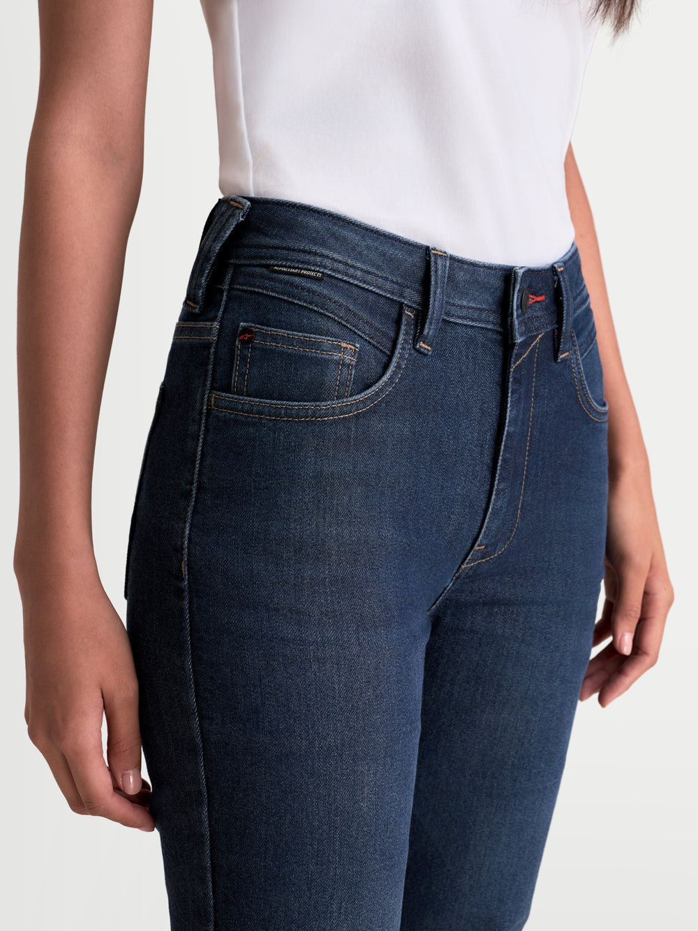 Alpinestars Stella Flex-AST 7 Denim Pants, women's urban motorcycle riding jeans, dark blue, close-up view of the waist and pocket construction worn by a model