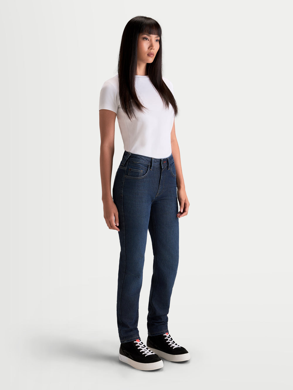 Alpinestars Stella Flex-AST 7 Denim Pants, women's urban contemporary motorcycle riding jeans in dark blue, side profile view worn by a model with a white t-shirt, featuring AA-rated single-layer technical denim and discreet protection.