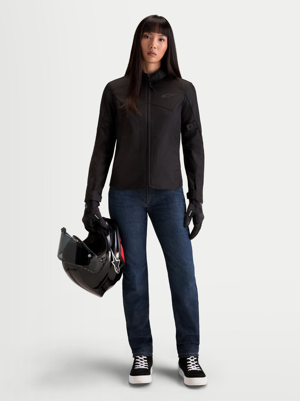 Alpinestars Stella Flex-AST 7 Denim Pants, women's urban contemporary motorcycle riding jeans in dark blue, worn by a model holding a helmet and matching jacket