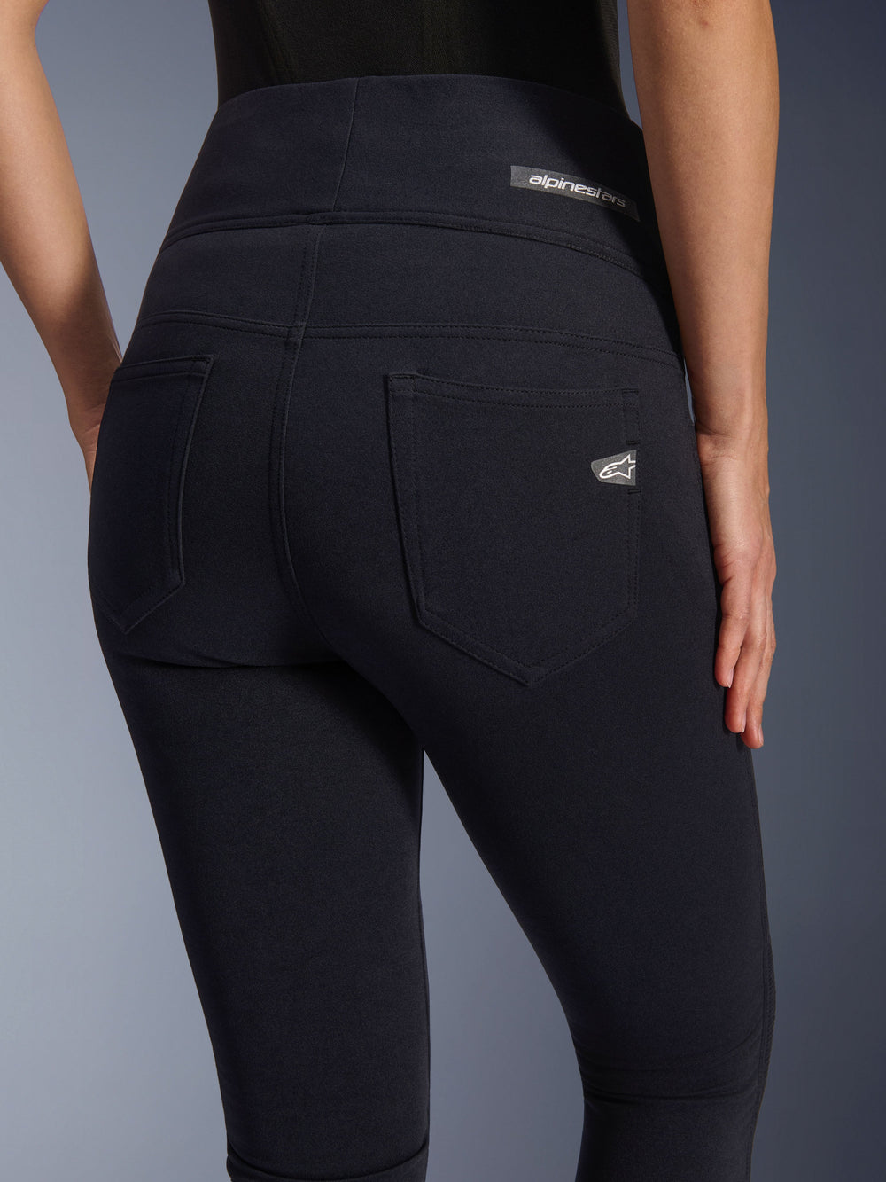 Alpinestars Stella Flex-Ast Leggings, Women's motorcycle leggings, Black, back view featuring high-waisted design, two rear pockets, Alpinestars logo on waistband and right pocket, form-fitting textile for urban riding