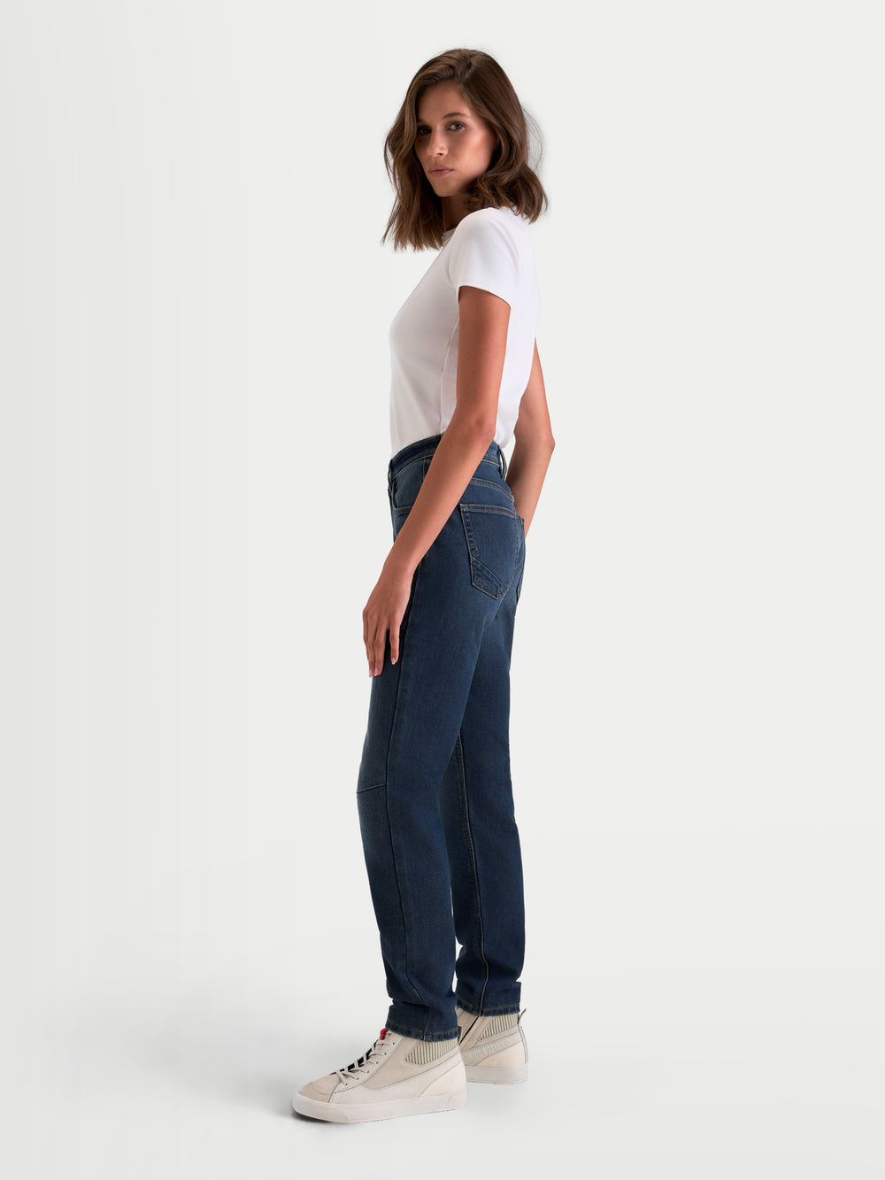 Alpinestars Stella Flex-AST 5 Denim Pants, women's urban motorcycle riding jeans in indigo washed, side profile view on a model wearing single-layer stretch denim with CE A class protection.