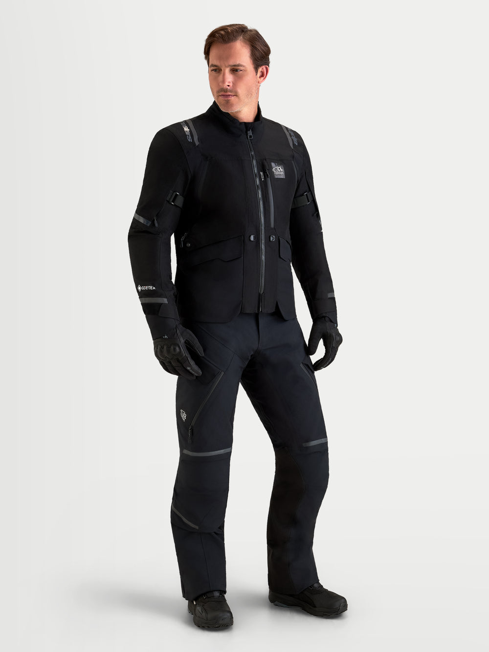 Alpinestars St-7 V2 2L Gore-Tex Jacket and Pants, men's all-terrain adventure touring motorcycle gear set in black, full-length view on a male model wearing waterproof textile apparel and gloves