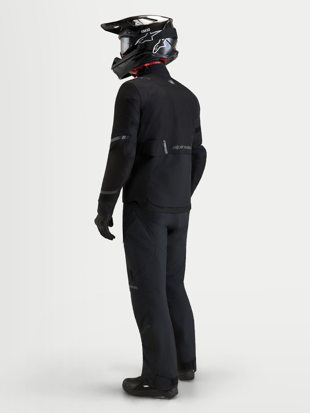 Alpinestars St-7 V2 2L Gore-Tex Jacket, men's adventure touring motorcycle jacket in black, rear view worn by a model wearing matching gear and helmet, waterproof textile construction.