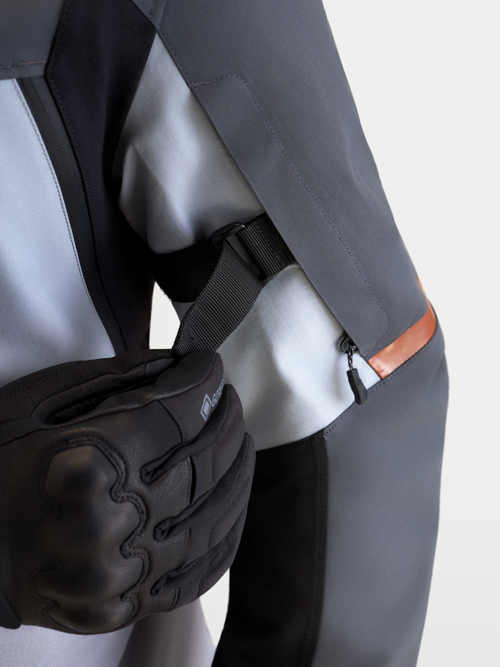 Alpinestars St-7 V2 2L Gore-Tex Jacket, close-up view of the sleeve volume adjustment strap being adjusted, Mid Gray and Black, men's adventure touring motorcycle jacket