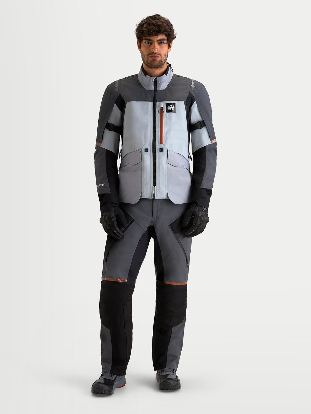 Alpinestars St-7 V2 2L Gore-Tex Jacket, men's adventure touring motorcycle jacket in mid gray, deep gray, and black, featuring GORE-TEX waterproofing and CE certified protection, worn by a model