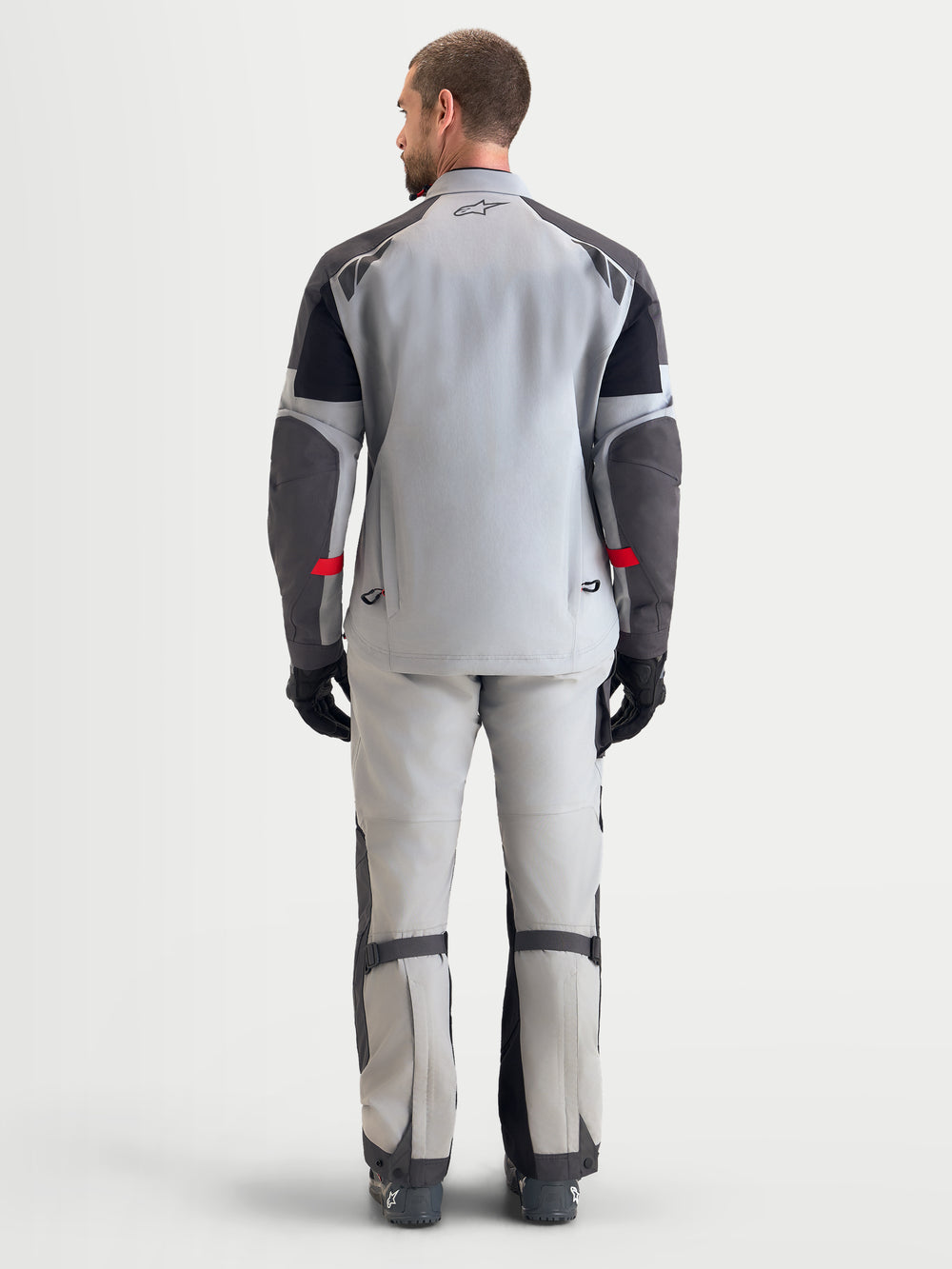 Alpinestars Arenis Gore-Tex Jacket, men's adventure touring motorcycle jacket in mid gray, deep gray, and black, rear view showing waterproof textile construction and integrated rear exhaust vents.