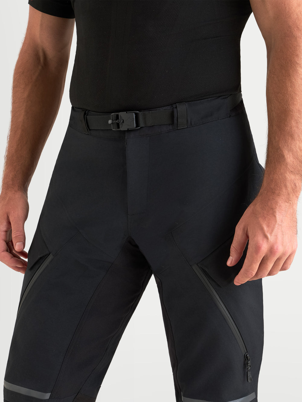 Alpinestars St-7 V2 2L Gore-Tex Pants, men's adventure touring motorcycle pants in black, close-up view showing magnetic waist closure and technical textile construction worn by a model