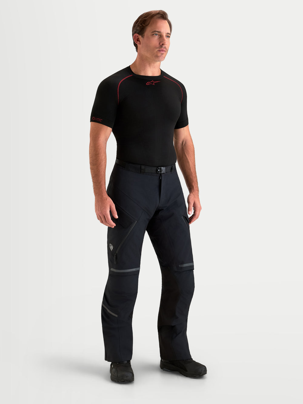Alpinestars St-7 V2 2L Gore-Tex Pants, men's adventure touring motorcycle pants in black, on-model front view showing waterproof textile construction, thigh vents, and protective riding gear