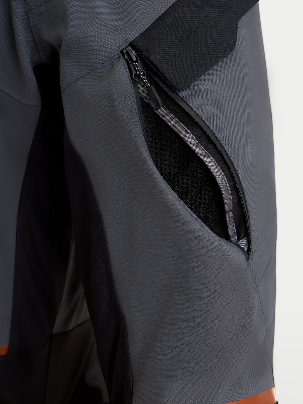 Alpinestars St-7 V2 2L Gore-Tex Pants, men's adventure touring motorcycle pants in deep gray and black, close-up view highlighting the zippered thigh ventilation opening and waterproof textile construction