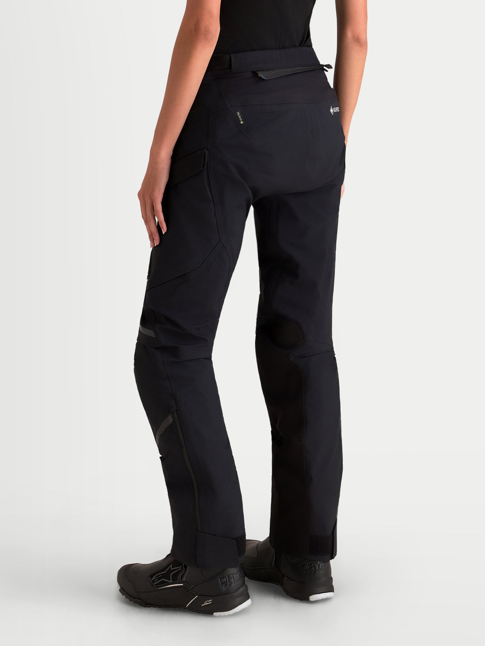 Alpinestars Stella ST-7 V2 2L Gore-Tex Pants Short, women's adventure touring motorcycle pants in black, rear profile view on a model showing waterproof textile construction and reinforcement details