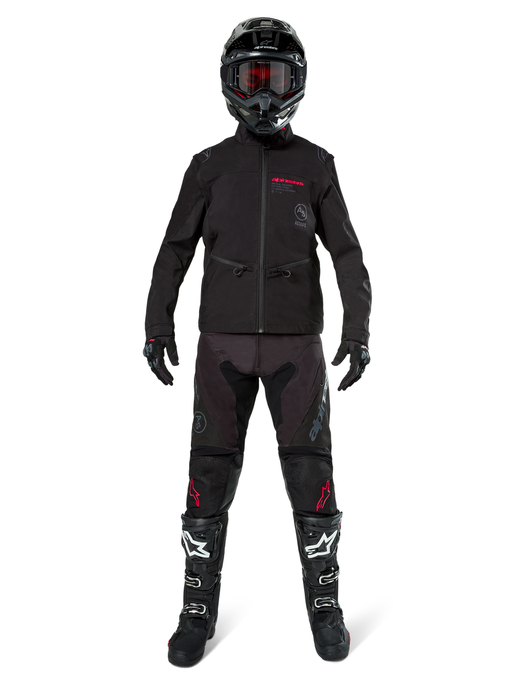 Motocross rider wearing the Alpinestars Lite-Dura Softshell Jacket in Black with red logo details, styled with matching black off-road pants, black helmet, and white and black boots, complete professional enduro racing gear.