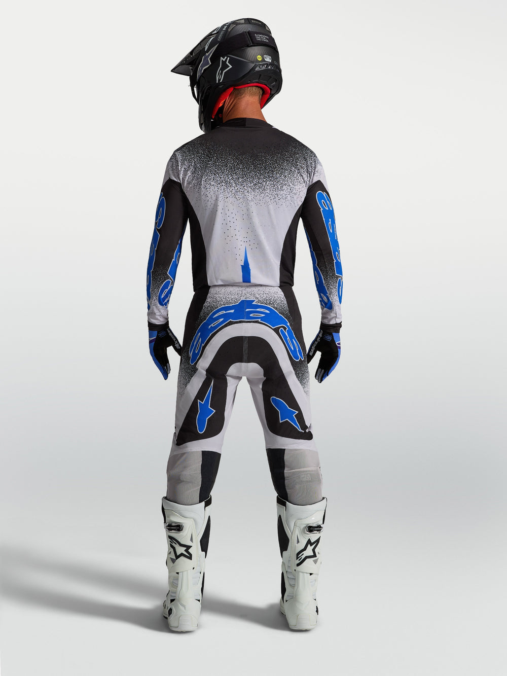 Alpinestars Supertech Hiten AFD Pants, men's motocross racing gear in blue and white, athletic rear view.