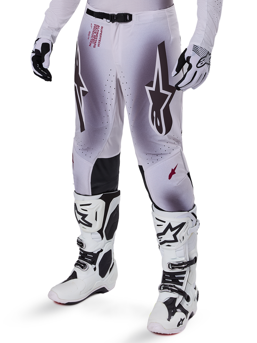 Alpinestars 2025 Supertech Maker Pants, Motocross Racing Pants, Silver and Black, featuring large star logos and red lettering, shown with matching white boots and gloves