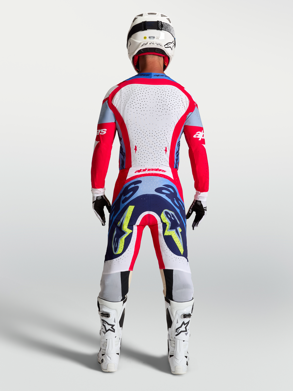 Alpinestars Supertech Dyna Pants, Fire Red and Navy Blue motocross racing gear for men, shown from the rear on model.