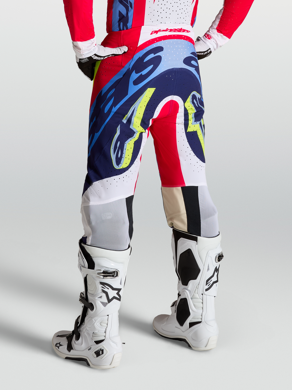Alpinestars Supertech Dyna Pants, red, white, and navy blue motocross pants with athletic race fit on-model.