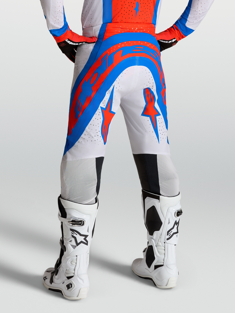 Alpinestars Supertech Vesta Pants, pro-level motocross pants in white, red, and blue with perforated stretch rip-stop fabric.