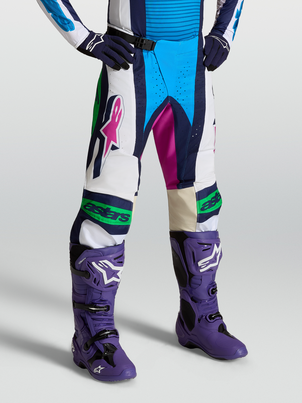 Alpinestars Techstar Maven Pants for motocross, blue and white on-model view with 600D polyfabric, stretch panels, and magnetic buckle.