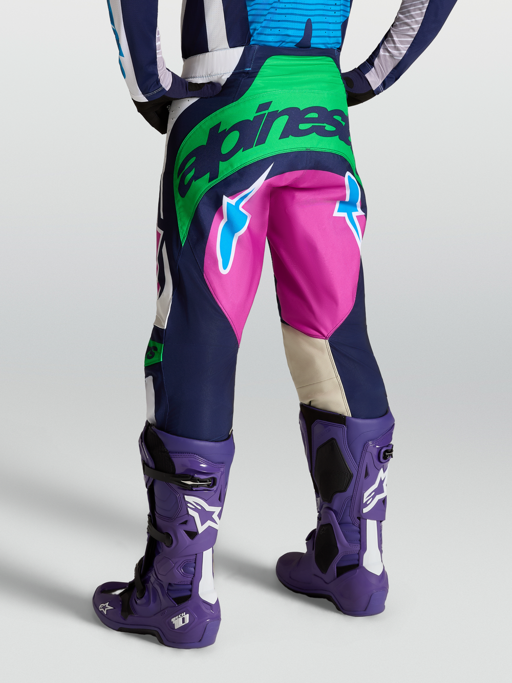 Alpinestars Techstar Maven Pants, Blue and Green motocross gear, rear view on model with Tech 10 boots.