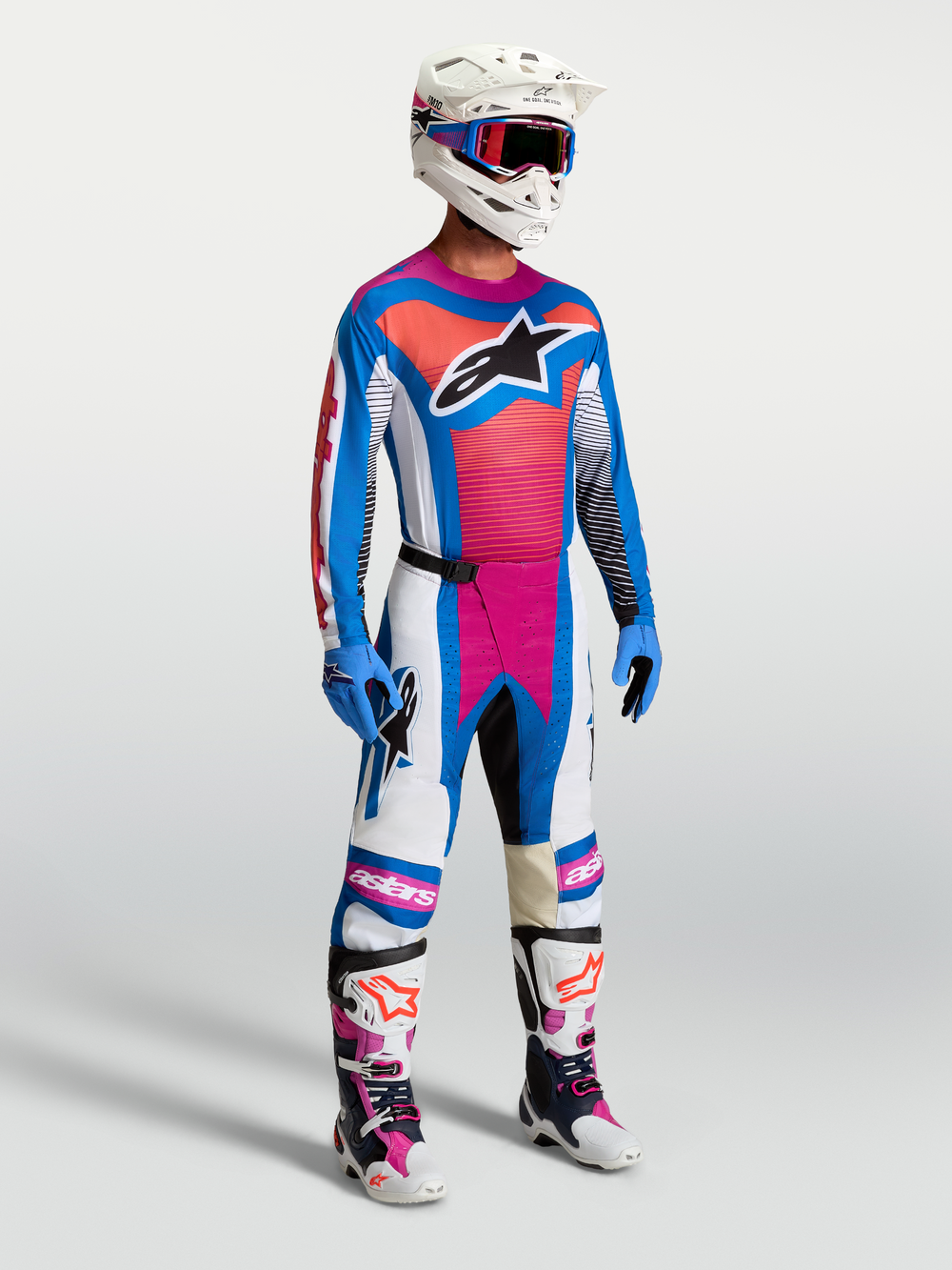 Alpinestars Techstar Maven Pants in White, Hot Coral, and Blue, shown on-model as part of a complete motocross racing gear set.