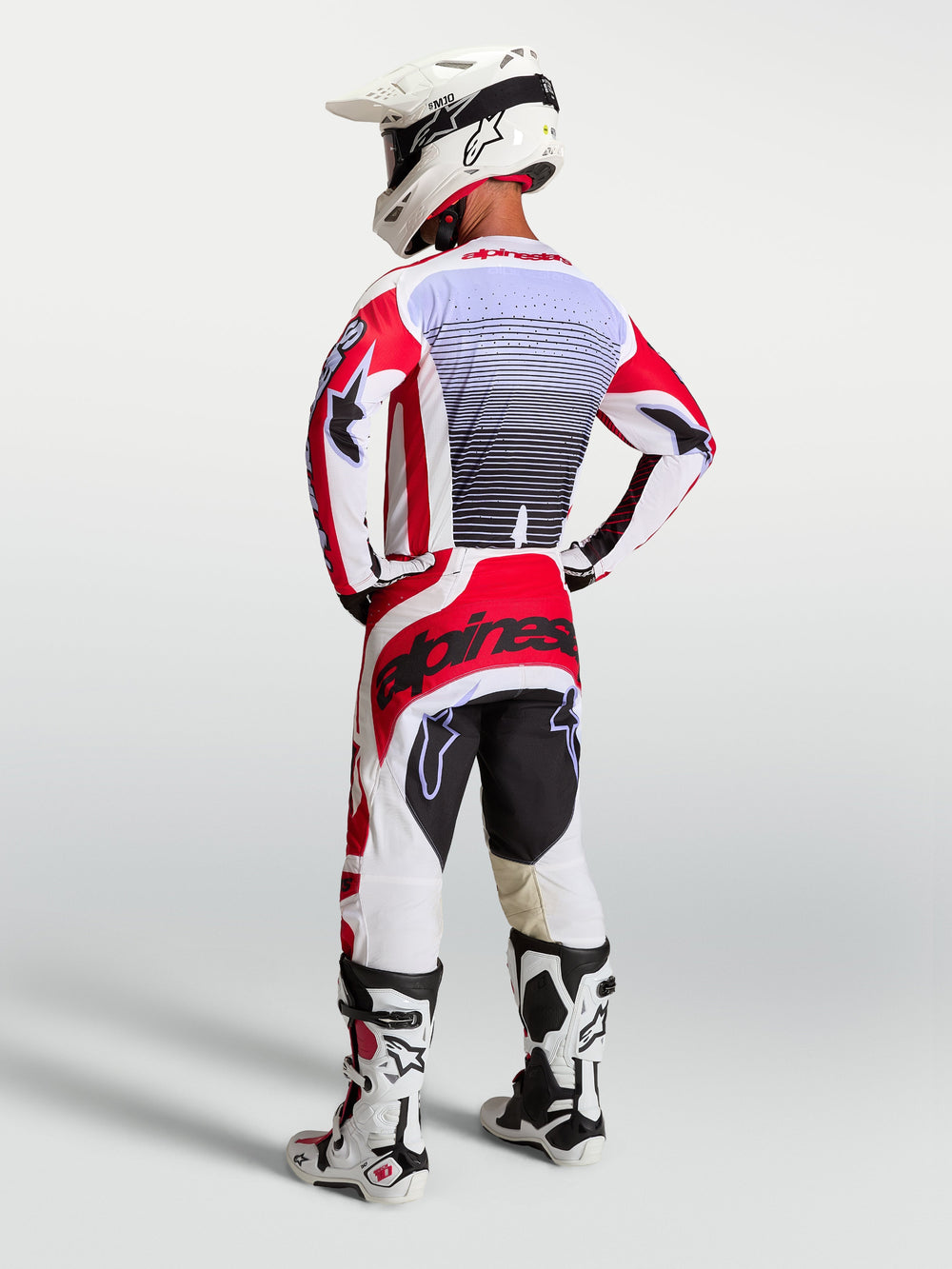 Alpinestars Techstar Maven Pants, Men's Motocross Racing Gear, Fire Red and White, rear view on rider with matching jersey.