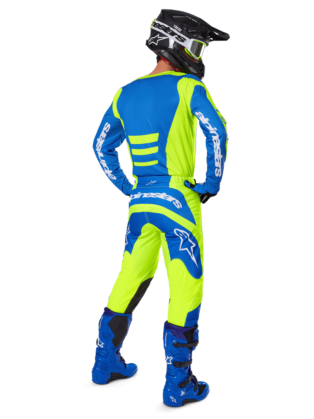 Motocross rider from behind wearing Alpinestars 2025 Fluid Haul Pants and matching jersey in Yellow Fluo and Blue, coordinated with blue boots and a black Alpinestars helmet, professional off-road racing gear