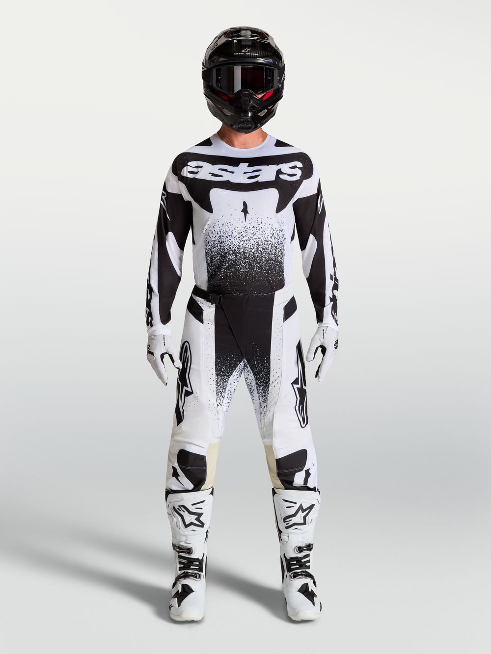 Alpinestars Techstar Swan Pants and jersey, white and black motocross gear set with matching boots on a model.