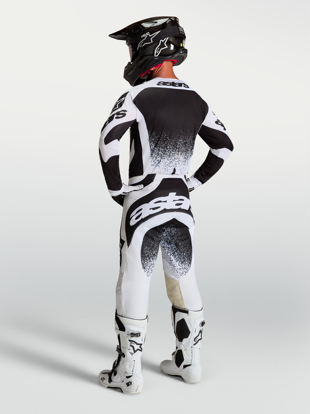 Alpinestars 2027 Techstar Swan Pants and Jersey, Black and White Motocross Racing Gear, back view of rider in full kit.