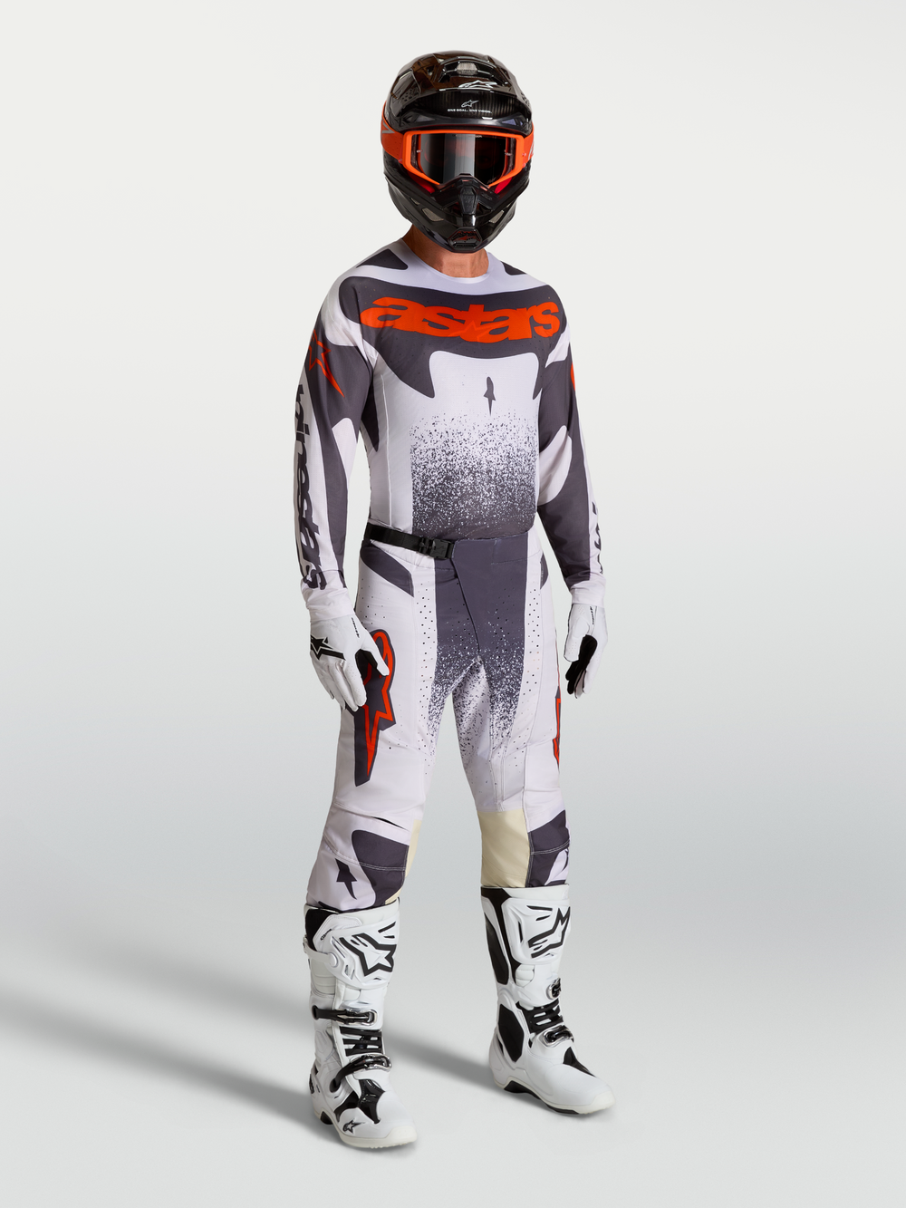 Alpinestars Techstar Swan Motocross Gear Set, men's racing pants and jersey in Light Lilac and Red Fluo with white boots.
