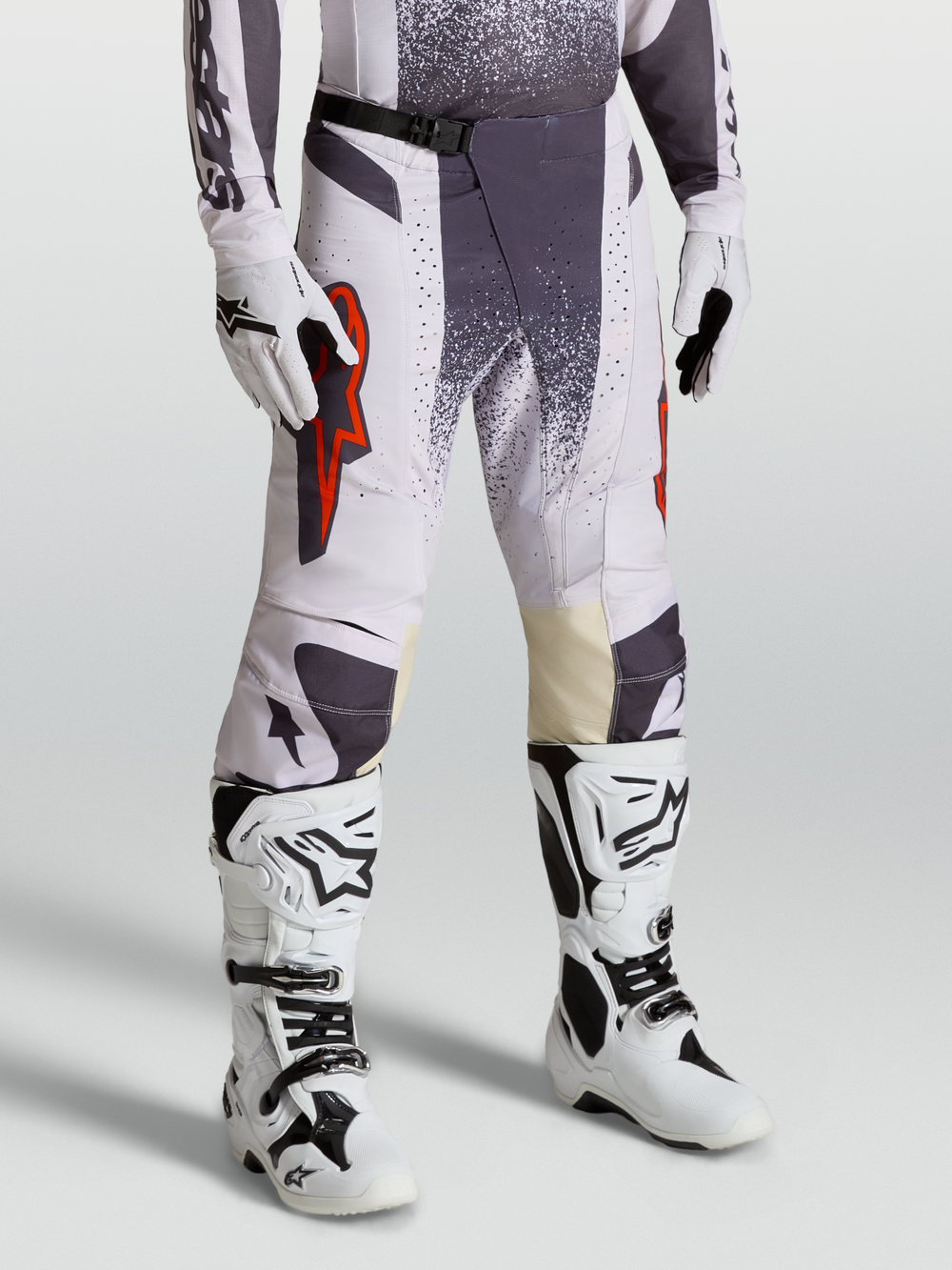 Alpinestars Techstar Swan Pants, Motocross Racing Pants for Men, Light Lilac and Dark Gray with Red Fluo accents, on-model shot with gloves and boots.