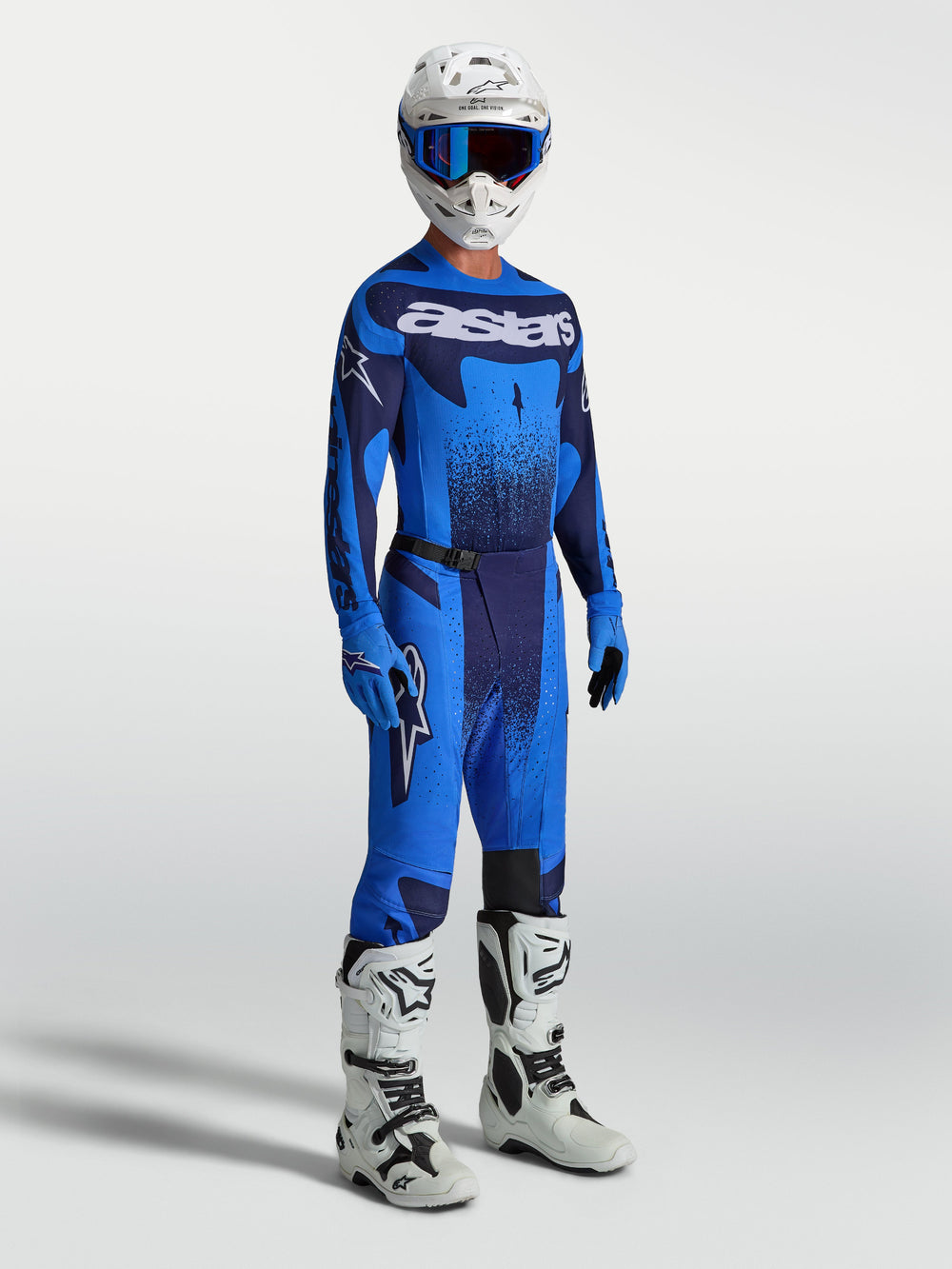 Alpinestars Techstar Swan Pants, blue and navy men's motocross gear, shown with matching jersey and white racing boots.