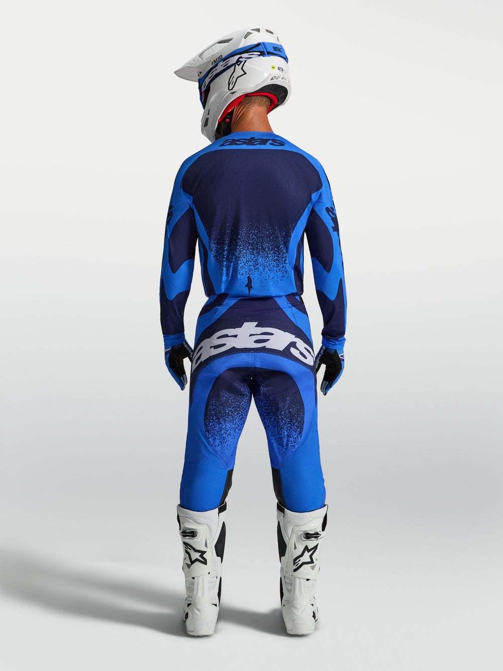 Alpinestars Techstar Swan Pants, Motocross Racing Gear, Men's, Blue and Deep Blue, shown from the back with white boots.