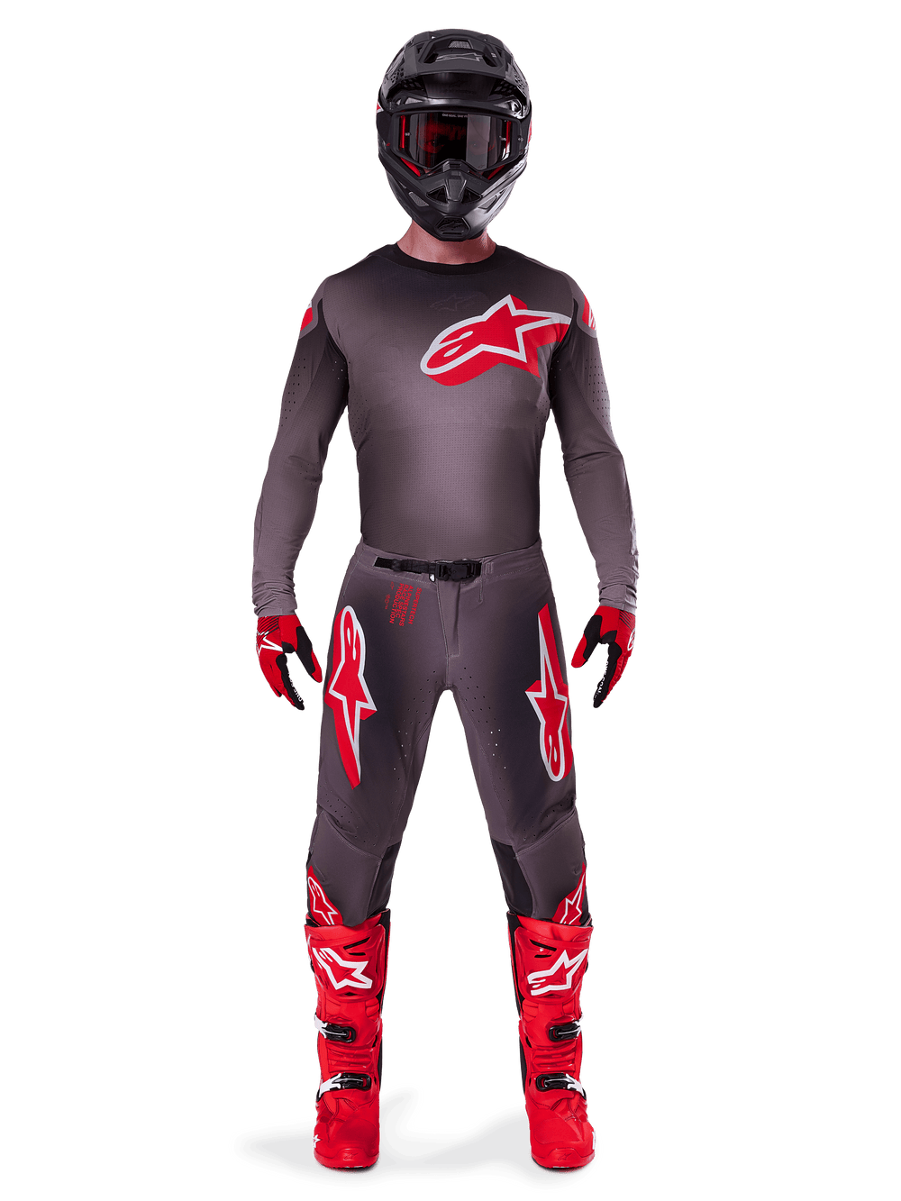 Motocross rider wearing complete Alpinestars 2025 Supertech Lipan gear set, Smoke Bright Red, featuring a dark grey jersey and pants with prominent red logos, black helmet with goggles, red and black gloves, and vibrant red motocross boots, coordinated professional racing outfit