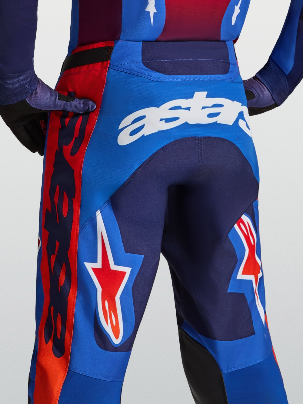 Alpinestars Racer Hunt Pants, men's blue and red motocross pants with white astars branding and star graphics.