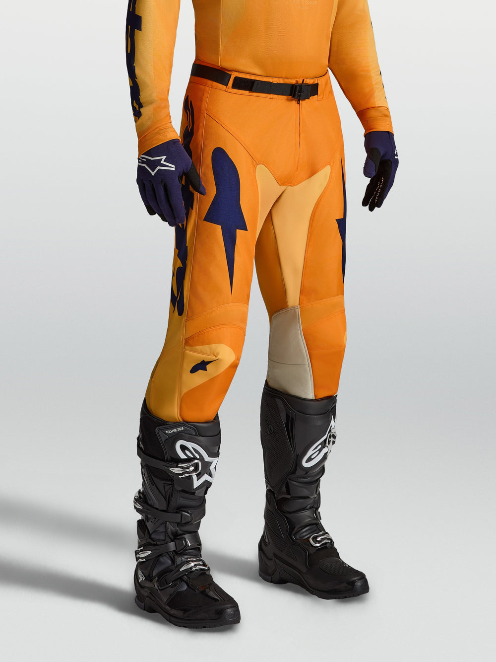 Alpinestars Racer Amber Pants, orange and deep blue motocross pants with stretch inserts and ergonomic pre-curved legs.