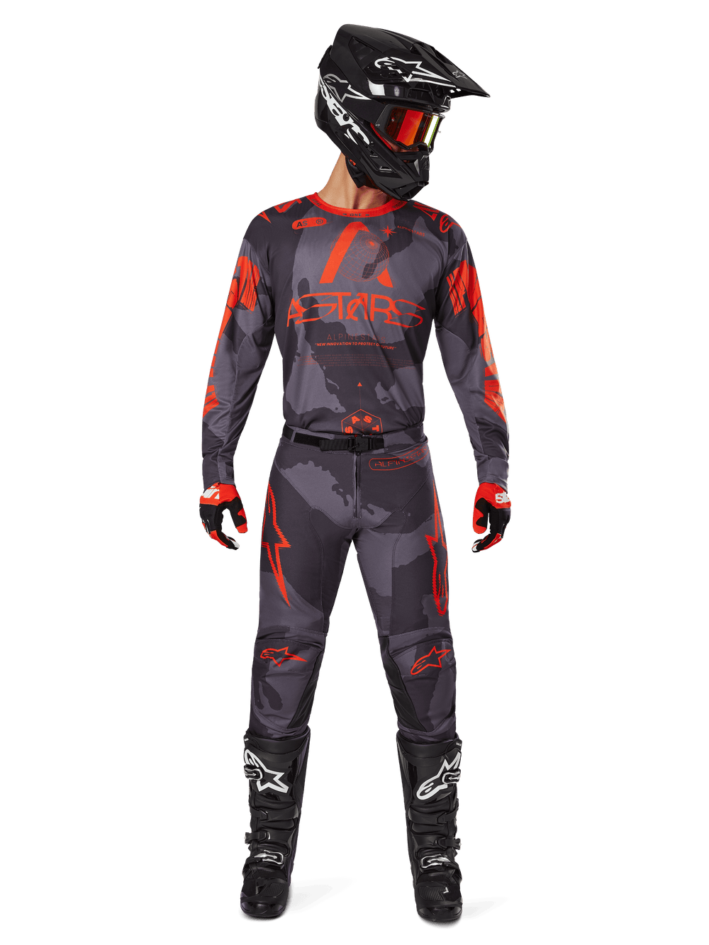 Alpinestars 2025 Racer Hollow Gear Set, Motocross Pants and Jersey in Gray Camo and Orange Fluo, worn with matching black helmet, red goggles, and black boots, featuring bold orange ASTARS logos and camo patterns, complete racing outfit for off-road performance.