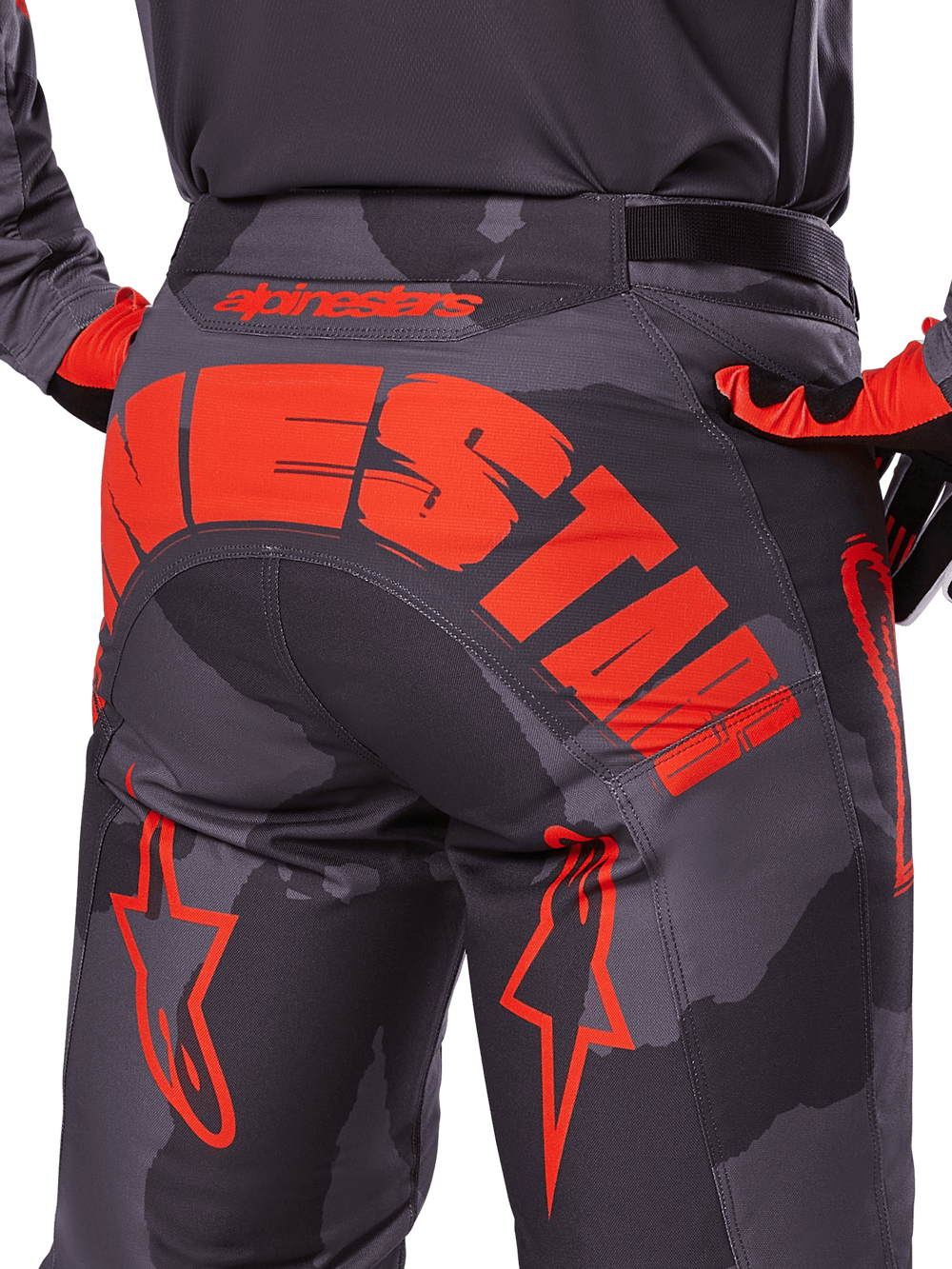 Alpinestars 2025 Racer Hollow Pants, Motocross Pants, Gray Camo Orange Fluo, rear view showing large orange Alpinestars logo across the seat, camouflage pattern with vibrant orange accents, durable off-road racing gear.