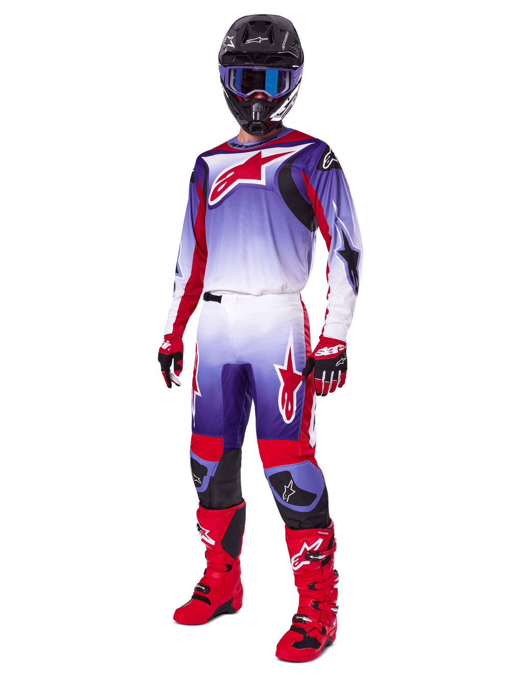 Motocross rider wearing complete racing gear, 2025 Fluid Wurx Pants and matching jersey in Purple Bright Red and White, large red Alpinestars logo, red boots and gloves, black helmet with blue goggles, coordinated outfit for off-road racing