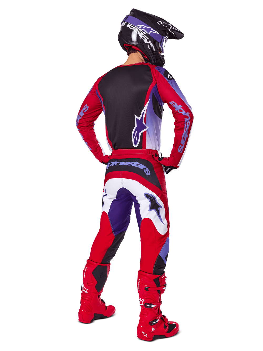 Motocross rider from behind wearing Alpinestars 2025 Fluid Wurx Pants, Purple Bright Red with white and black accents, matching jersey, black helmet, and red boots, coordinated outfit for off-road racing