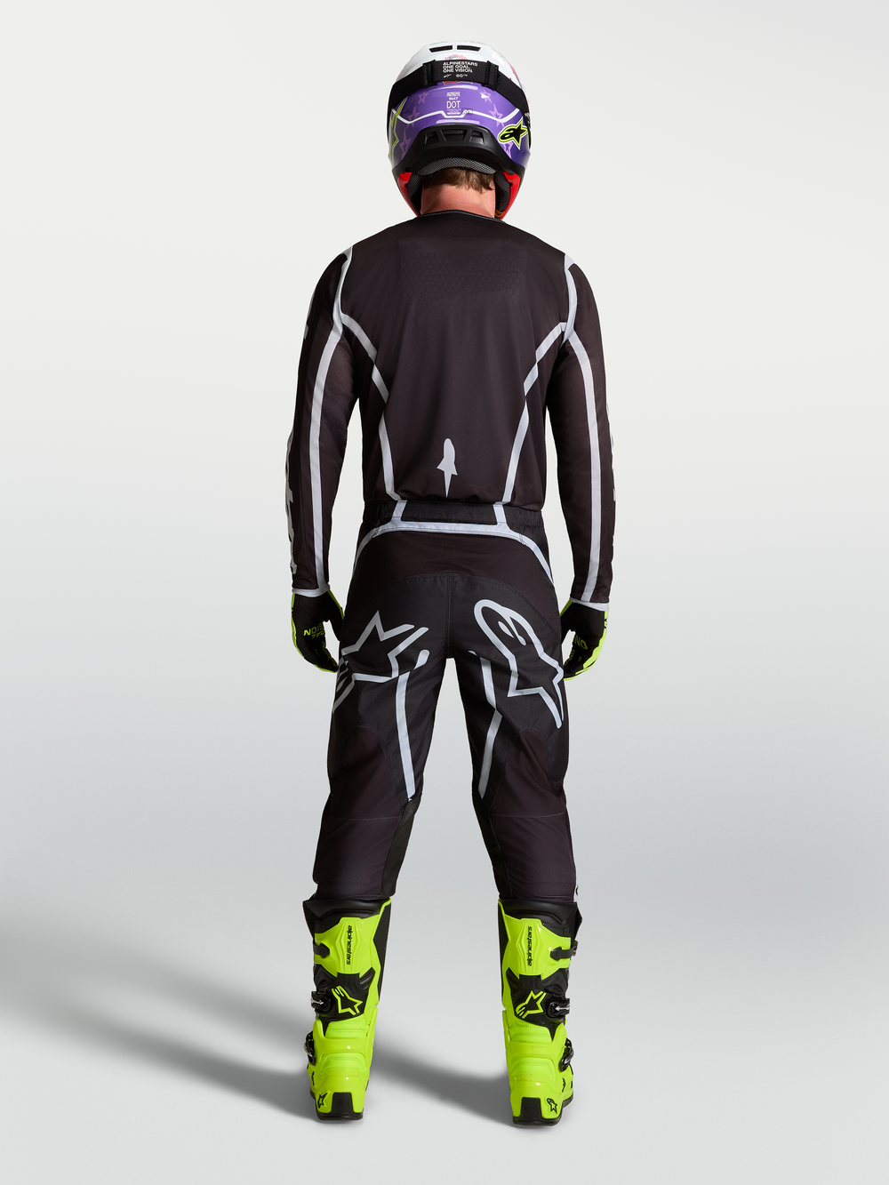 Alpinestars Fluid Apex V2 Pants, Men's Motocross Pants, Black and Silver, rear view on rider with ergonomic sport fit.